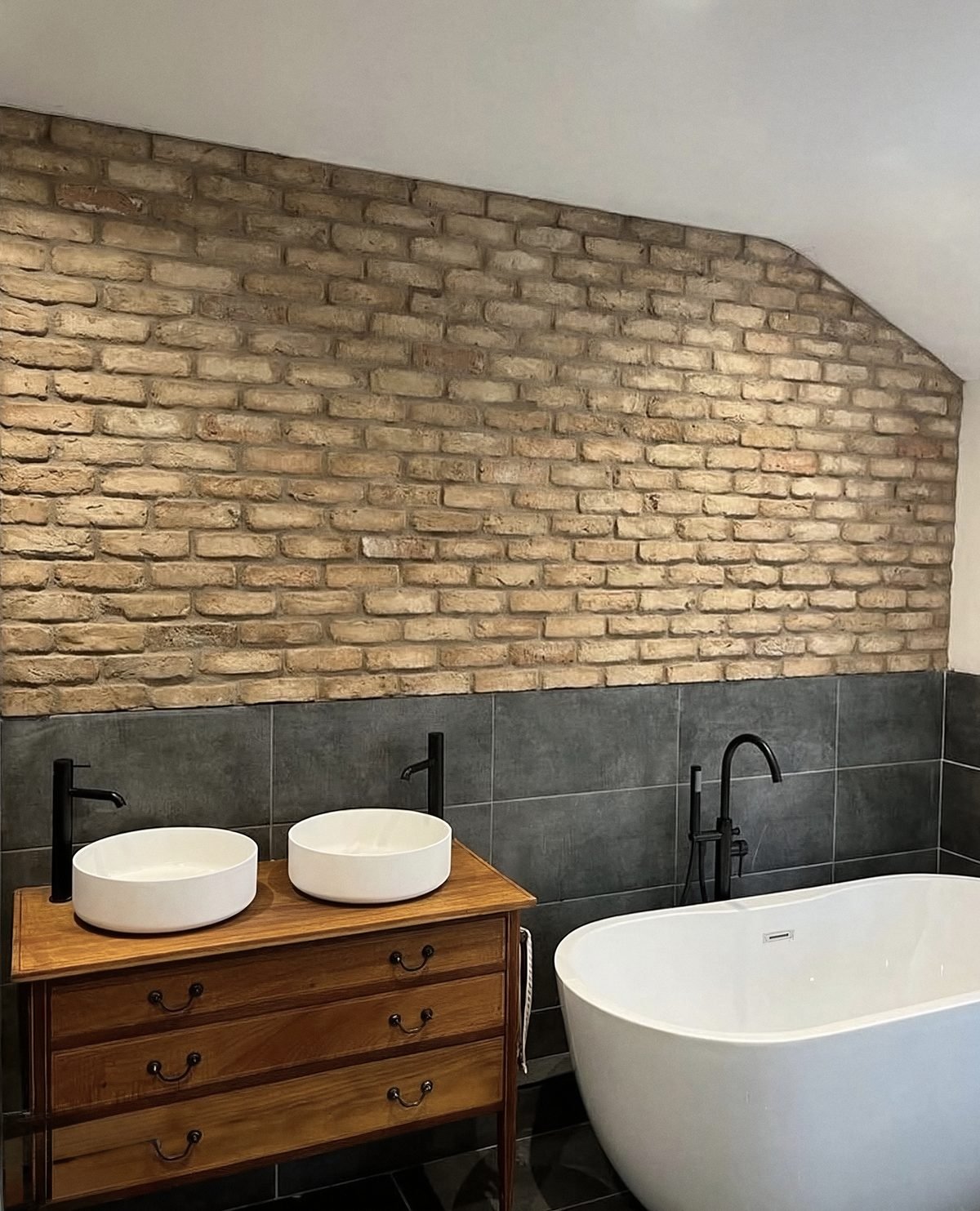 Rustic bathroom with exposed brick wall and repurposed dresser vanity