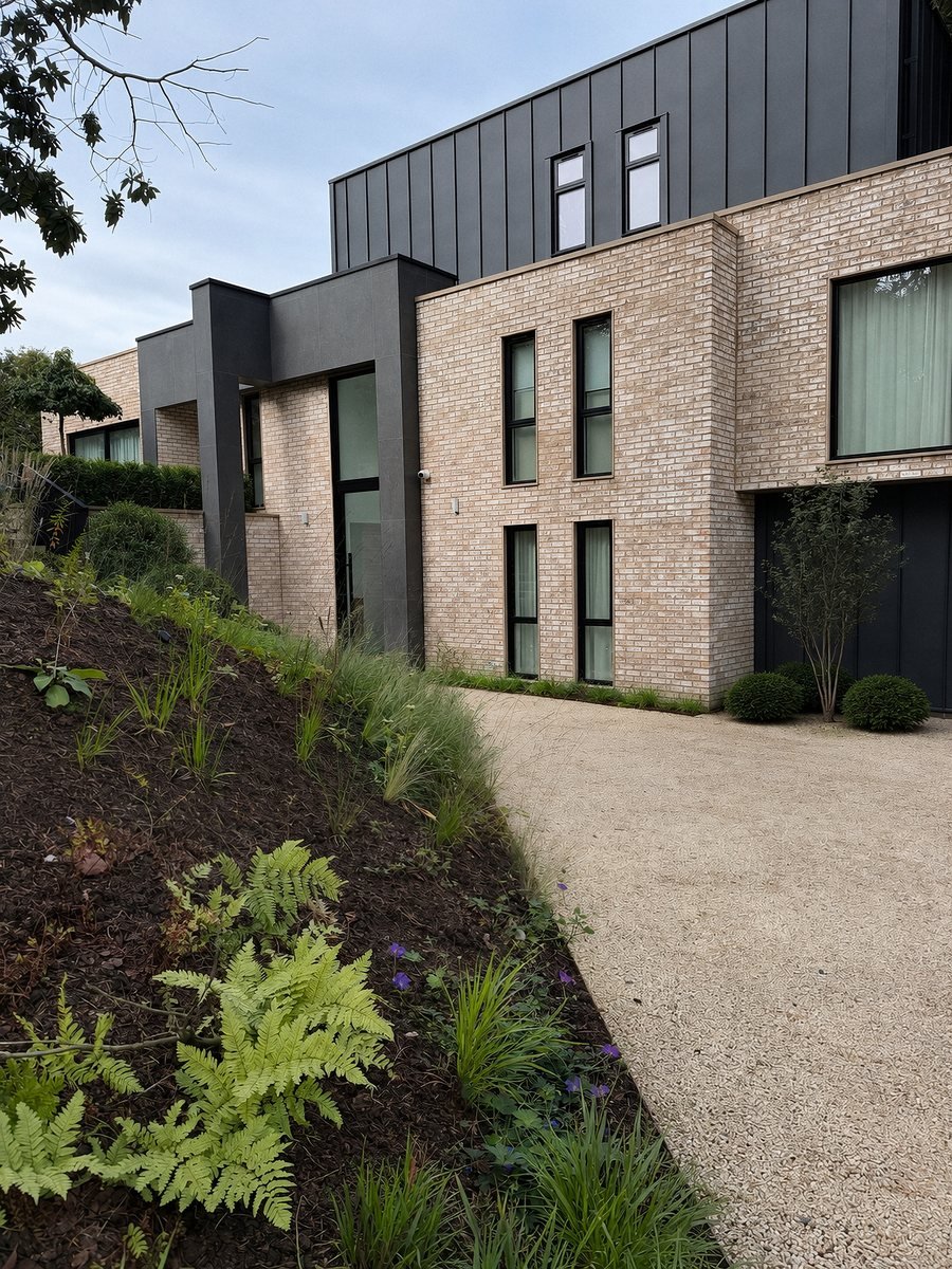 Same side of the new-build finished in buff brick slip cladding