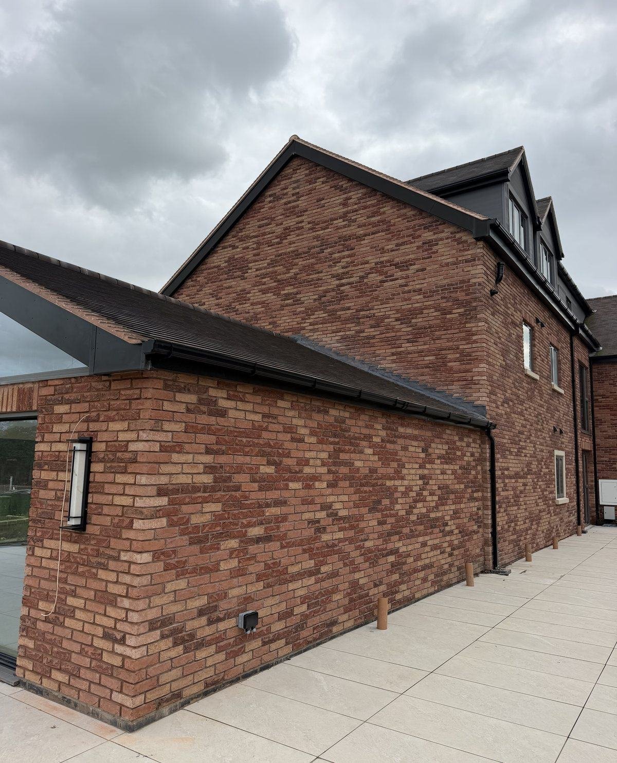 The same side elevation finished in red brick slip