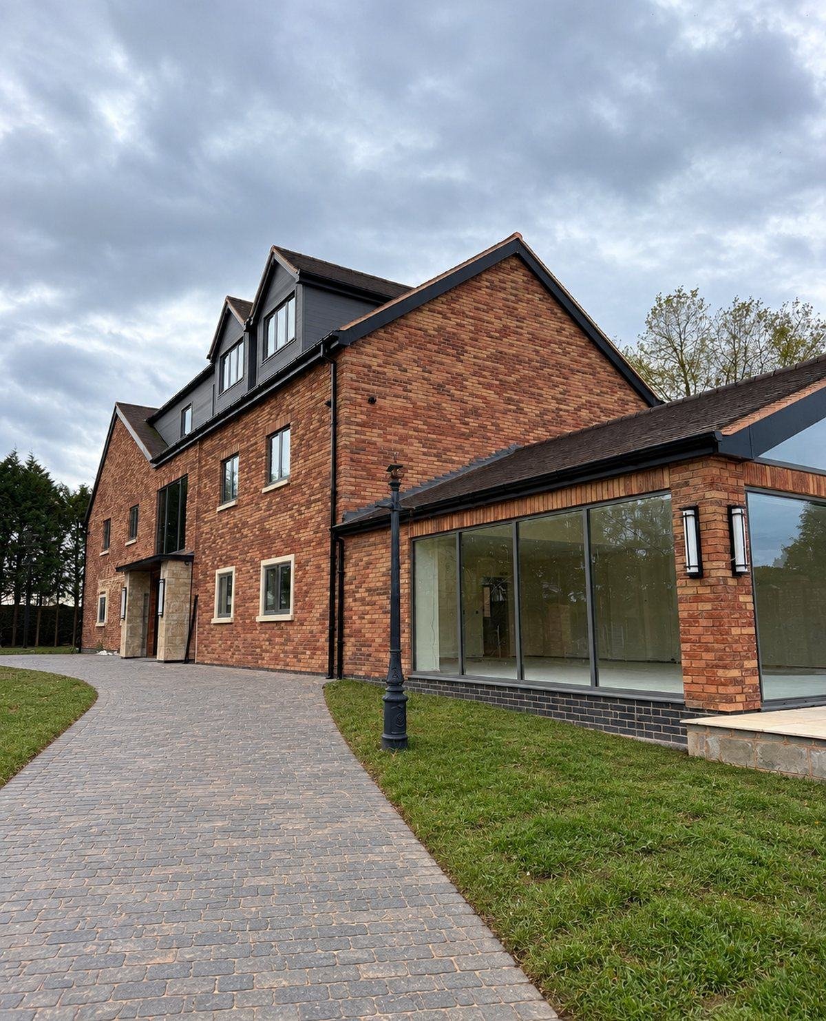 The finished new-build from the driveway, red brick slip throughout