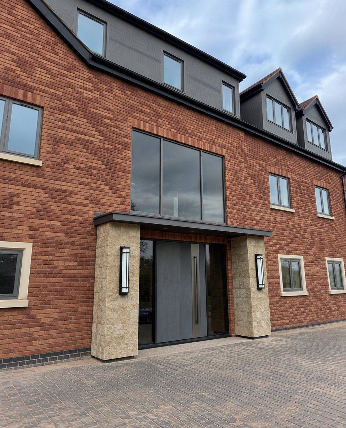Finished front entrance of the new-build in red brick slip